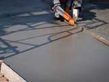 worker finishing surface of newly poured concrete