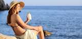 Woman on holidays on the beach applying sunscreen protection on leg with the horizon in the background. Formulate your new sun care products with our bio-based, biodegradable film forming polymers and synthetic polymers to achieve superior water resistance, higher SPF values, broad-spectrum protection and pleasant aesthetics. 