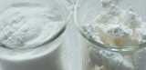 Two product samples in beakers with Expancel expanded thermoplastic microspheres lightweight fillers, with extremely low density. 
