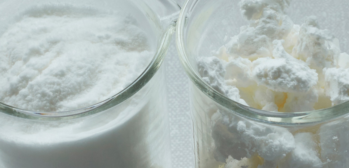 Two product samples in beakers with Expancel expanded thermoplastic microspheres lightweight fillers, with extremely low density. 