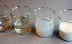 four beakers with colloidal silica at different stage of gelling from completely disolved to gelified