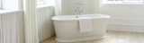 White acrylic bath on wooden floor