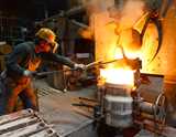 Man with protection gear working with high temperature oven 