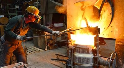 worker in a foundry casting a metal workpiece