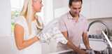 Happy couple washing dishes together. Nouryon’s ingredients provides essential functionalities to dishwash detergents such as cleansing, wetting, dispersing, foam, alkali stabilizing and degreasing.