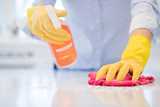 Person cleaning countertop with cleaning gloves