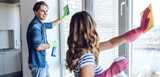 Young happy couple washing windows while doing cleaning at home. Nouryon’s specialty surfactants, hybrid polymers, chelates, colloidal silica, hydrogen peroxide and sodium hypochlorite are used in a variety of home care cleaning products. 