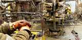 Offshore oil rig worker preparing tool and equipment for oil and gas drilling well. 