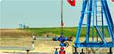 Land production site with pumpjack and wellhead