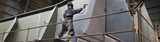 Worker using spray equipment for industrial coating. With Levasil colloidal silica in your industrial coating formulation you can produce durable metal coatings that shield steel and prevent corrosion. 