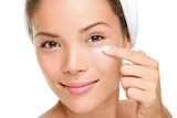 Woman applying facecream 