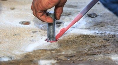 Injection adhesive chemical into hole for preparation anchor bolt 