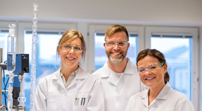 Three people in white laboratory coats