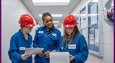 3 women looking at a plan