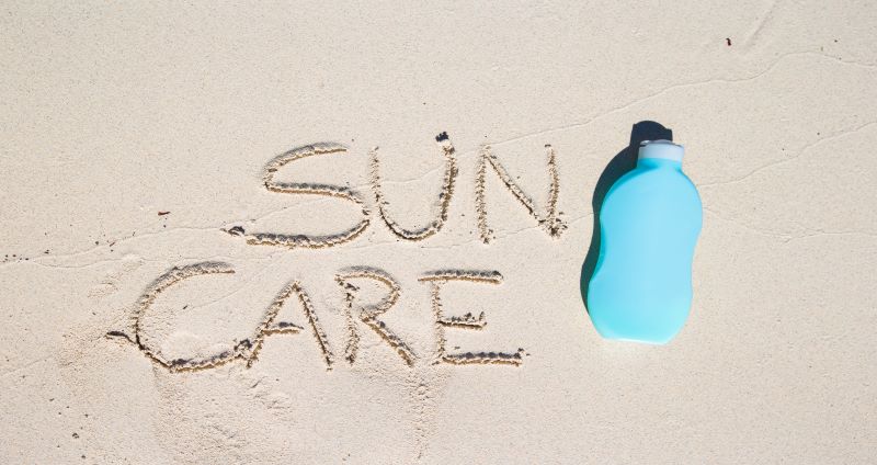 sunscreen bottle on sand.jpg